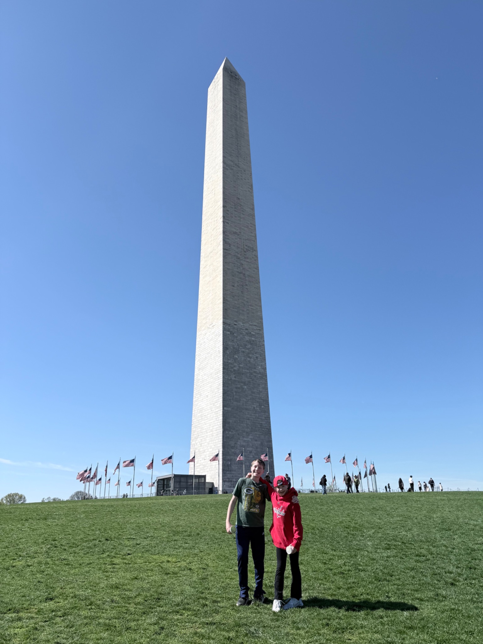 Children standing near the Washington Monument during a family trip to Washington DC